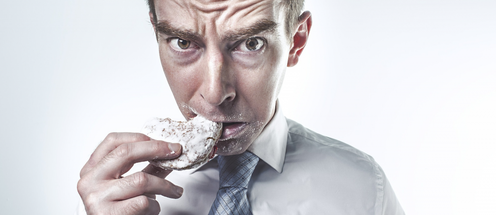 man eating donut